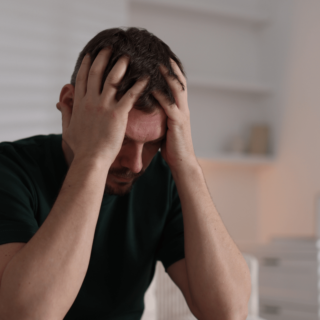 Man with head in Hands